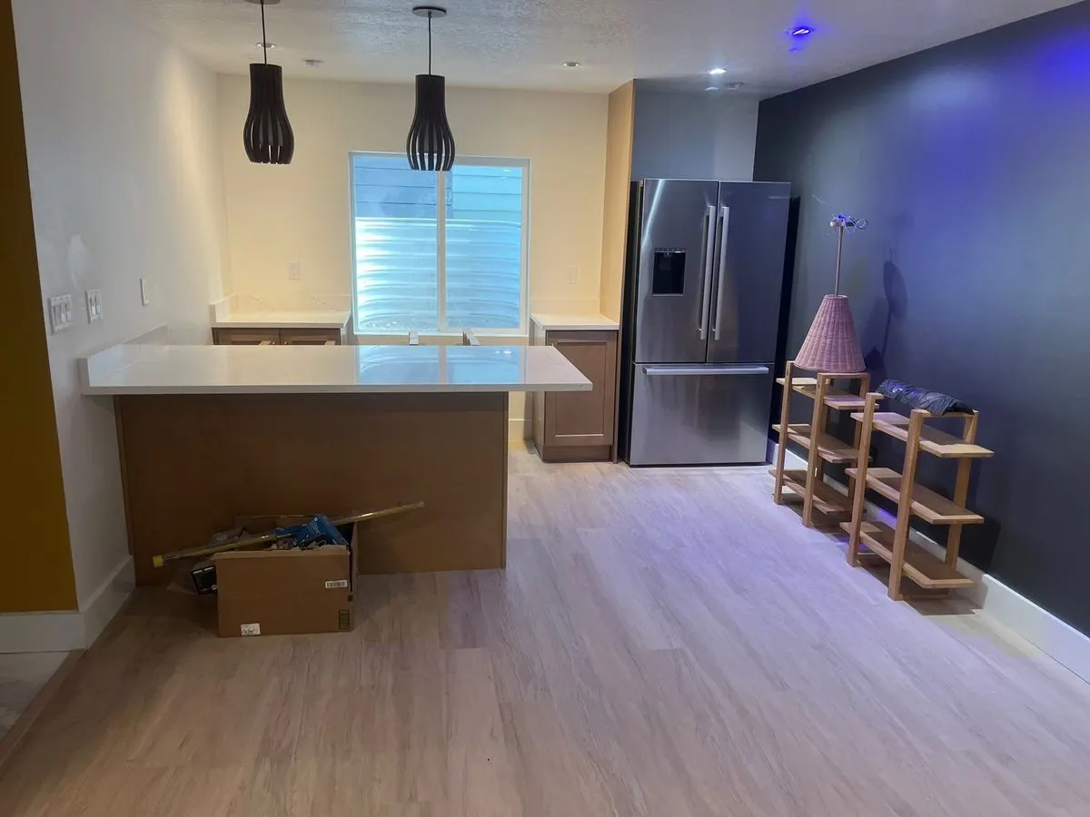 Finished basement kitchenette with peninsula and pendant lights