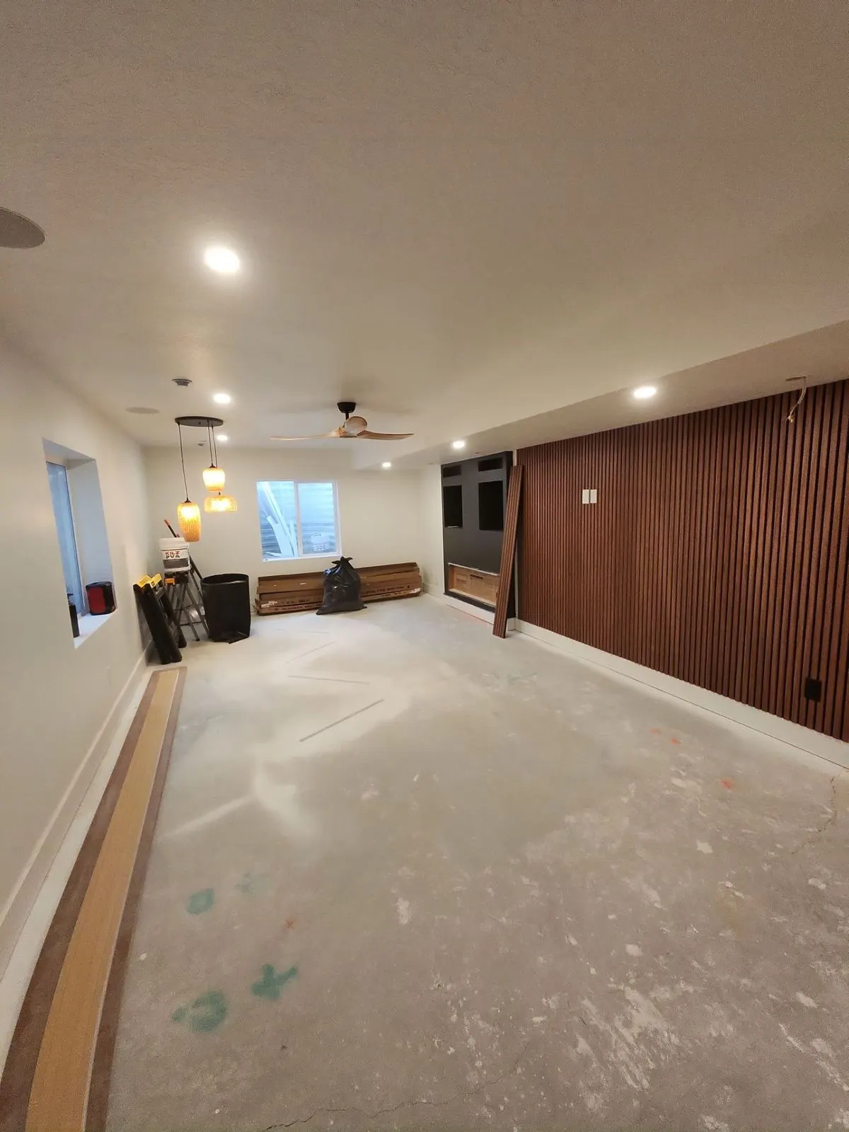 Finished basement living area with wood slat accent wall