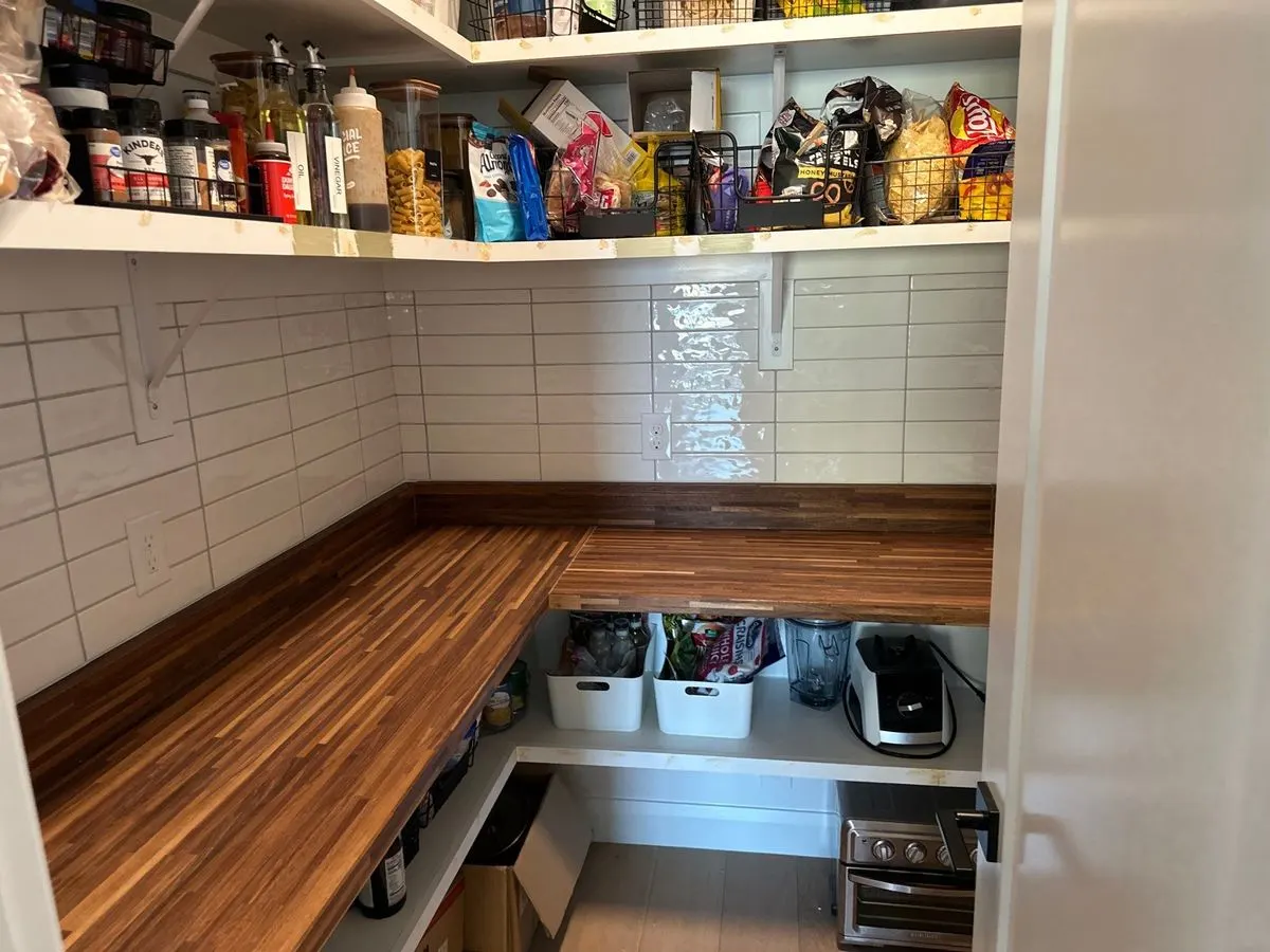 Pantry with subway tile backsplash and butcher block counters